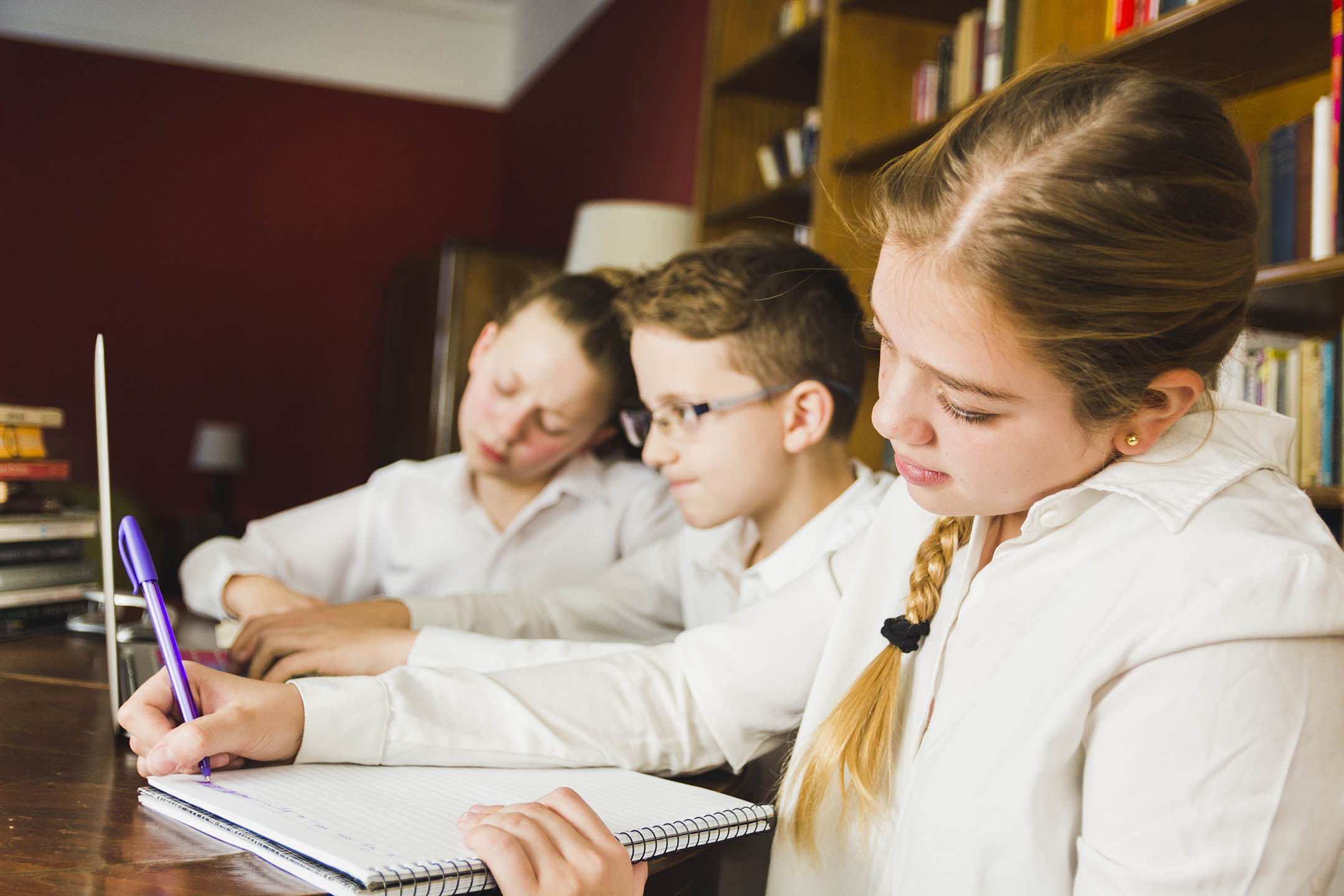 Kids doing work in a school library.